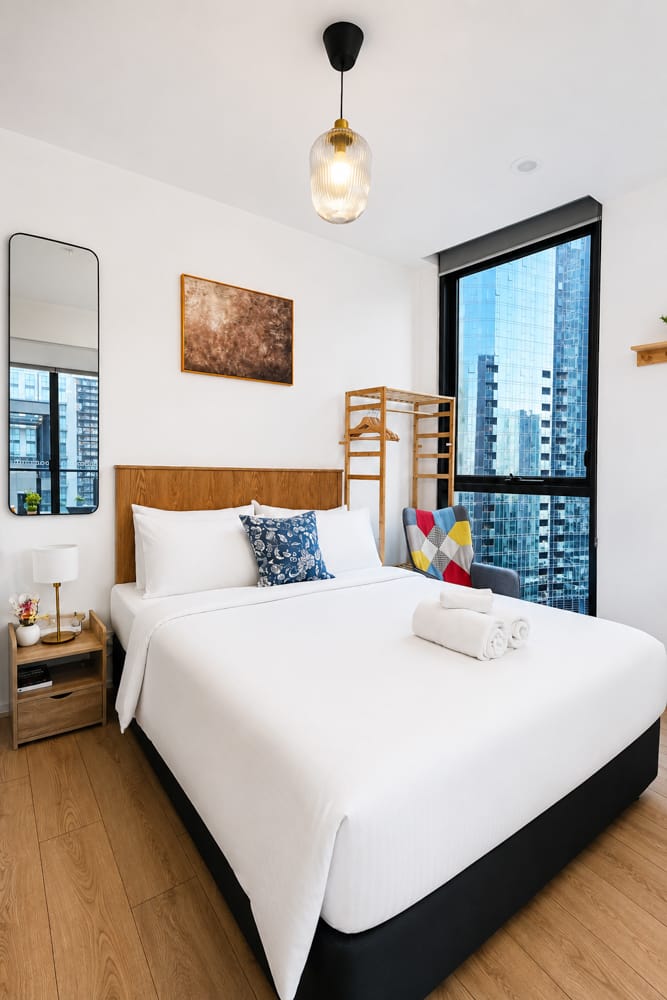 Melbourne apartment bedroom with city skyline view, photographed by Melbourne Property Media